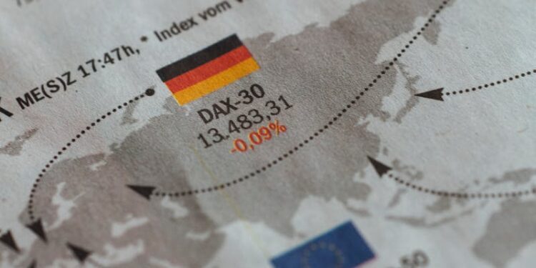 From above of business newspaper with trading indexes and flags of Germany France and European Union