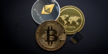 A striking image of Bitcoin, Ethereum, and Ripple coins illustrating modern digital currency.